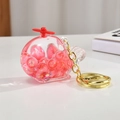 Detailed close-up of helicopter keychain with pink glitter beads and gold chain - Light Gold Chain + Luminous Aircraft / Red