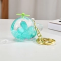 Detail of creative helicopter keychain with green glitter beads in liquid acrylic case - Light Gold Chain + Luminous Aircraft / Green