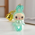 Cute mint green acrylic rabbit keychain with a large gold bell on a white display stand - Green
