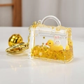 Macro shot of liquid glitter keychain with white bunny and yellow duckling miniature - Mini Bag