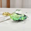 Macro detail of acrylic airplane keychain with sparkling green quicksand and liquid inside - Light Gold Chain + Fighter Jet / Iridescent Green