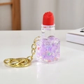 Portachiavi a rossetto luminoso con sabbie mobili viola su una superficie bianca - Viola