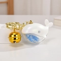 Detail of laser acrylic whale keychain with pearlescent finish and golden bell charm - Gold Clasp Whale Bell / White