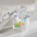 Macro shot of liquid-filled square bottle pendant with macaron beads and lobster clasp - White