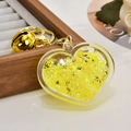 Detail of yellow glitter heart keychain with golden bell on a dark wood box - Light Gold Chain + Luminous Heart + Bell / Lemon Yellow