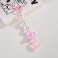 Pink heart acrylic keychain with bow and beads for bag charm accessory on white background - Pink