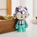 Creative chrome astronaut keychain in purple and green with Luck text on a gold ring - Green Purple