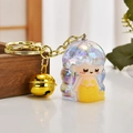 Detail of iridescent mermaid keychain with golden bell and polished acrylic dome shell - White Pencil Sharpener Style