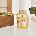 Iridescent cartoon girl with rabbit figurine keychain featuring golden metal hardware detail - Gold Bear Pencil Sharpener