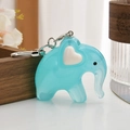 Blue acrylic elephant keychain with heart detail and silver metal clasp on wooden background - Blue