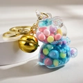Macro shot of unicorn keychain with colorful beads and a polished golden bell - Blue Unicorn