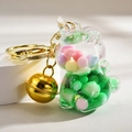 Detail of unicorn liquid keychain with green fluid, colorful beads and a golden bell - Green Unicorn