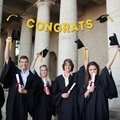 Congrats graduation banner with gold glitter letters and black mortarboard caps - Gold CONGRATS