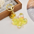 Macro detail of butterfly acrylic keychain with yellow liquid, gold glitter and pearls - Glitter Lemon Yellow