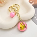 Close-up of pink 3D monkey keychain with gold ring, bell and Chinese zodiac pendant - Pink Monkey / Light Gold Chain + Small Gemstones + Bell