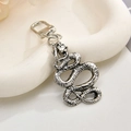 Macro view of vintage silver snake keychain showing detailed scale texture and metal ring - Python