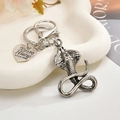Detailed view of silver cobra keychain with snake scales, lobster clasp and heart charm - Cobra