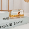 Detail of creative bus liquid quicksand keychain with stars and cartoon animal inside - Gold