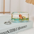 Creative bus quicksand keychain with capybara doll and liquid glitter on a book - Gold Blue
