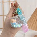 Macro shot of heart-shaped liquid quicksand keychain with cute bear figures and glitters - Heart Lock / Gradient Rope + Blue Bear