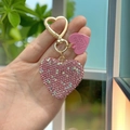Sparkling pink rhinestone heart keychain with gold-tone lobster clasp shown in hand - Pink