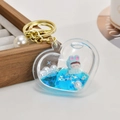 Portachiavi a cuore in acrilico con sabbie mobili, bambola e anello in metallo oro - Catena Oro Chiaro + Cuore + Perla / Blu