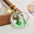 Macro view of heart-shaped acrylic oil keychain with floating green bunny and white pearls - Light Gold Chain + Heart + Pearl / Green