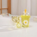 Luminous yellow milk tea keychain with floating glitter and rainbow wrist strap - Daisy Quicksand Glowing Milk Tea Cup / Lemon Yellow