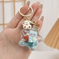 Star-shaped liquid sand keychain with cute blue bear, strawberry charm, and gold ring - Blue Without Bear