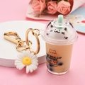 Green bubble tea cat keychain featuring a white daisy charm and golden lobster clasp - Little Daisy Charm Style / Brown
