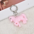 Pink acrylic horse keychain with silver metal ring on white plush background - Pink