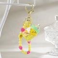 Macro detail of acrylic kitten bottle keychain with yellow flowing liquid and beads - Keychain Chain + Bottle Cat / Lemon Yellow