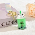 Cute mint green milk tea cat keychain with sparkling liquid sand and holographic strap - Iridescent PVC Strap Style / Green
