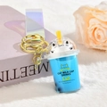 Blue bubble tea cup keychain featuring white cat and colorful transparent strap - Iridescent PVC Strap Style / Blue