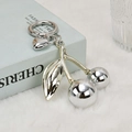 Polished silver cherry keychain with heart pendant on blue book and faux fur - Silver