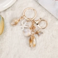 Starfish and seashell keychain variant with gold metal ring on plush background - Simulated Shell and Starfish Combination (6)