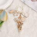 Ocean theme keychain with brown seashell and starfish charms on a golden metal ring - Brown Textured Conch Charm Combination (4)