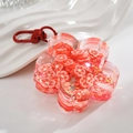 Portachiavi in acrilico con fiore arancione, glitter mobili e gancio in metallo - Rosso