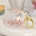Detail of a clear acrylic capsule keychain with a white bear and red floating glitter - Light Pink Seal