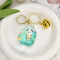 Dettaglio portachiavi panda a forma di ghiacciolo con glitter e campanellino - Verde