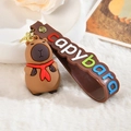 Close-up of cute brown capybara soft glue keychain with red scarf and wristband - Letter Strap And Capy / Red Sailor Scarf Necktie with Stars