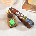 Cute capybara keychain with green turtle and brown wrist strap on a plush background - Letter Strap And Capy / Turtle