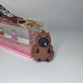 Detailed view of Capybara keychain with creative blue decoration and brown wrist strap - Letter Strap And Capy / Runny Nose