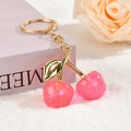 Detail of pink glitter cherry pendant with golden leaves on a soft plush background - Smooth Chain Buckle - Sequin Glitter