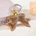 Close-up of luxury rhinestone bow keychain with elegant velvet base and gold ring - Gold with Rhinestone Rope and Small Ring