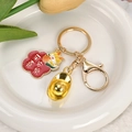 Porte-clés dragon doré du zodiaque avec lingot de fortune et pendentif fleur chance - Mignonne Étiquette Paix et Joie de Lingot d'Or