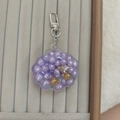 Detailaufnahme von lila Muschel-Schlüsselanhänger mit Treibsand-Perlen und silbernem Haken - Karabiner-Stil / Lila