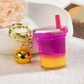 Detail of creative bubble tea keychain with liquid gradient colors and a golden bell - Light Gold Buckle + Bell + Oil-filled Milk Tea Cup / Magenta Purple