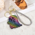 Close-up of rainbow rhinestone ghost keychain with golden lobster clasp on soft plush - Rainbow Rope Style