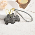 Close-up of sparkling rhinestone bat keychain with gold-tone metal clasp on faux fur - Silver Black Rope Style
